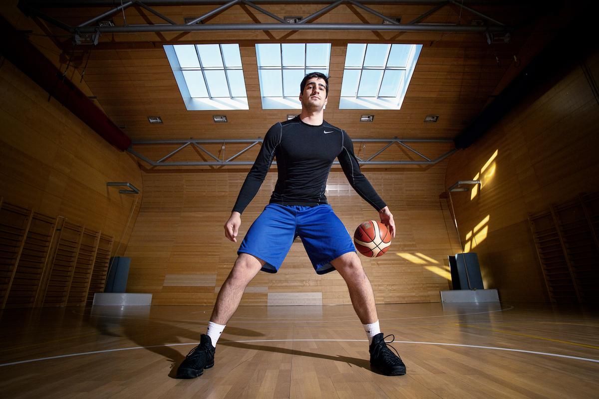 Zurab Kereselidze stojí v tělocvičně s basketbalovým míčem